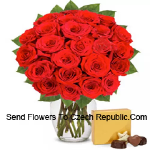31 Red Roses With Some Ferns In A Glass Vase Accompanied With An Imported Box Of Chocolates