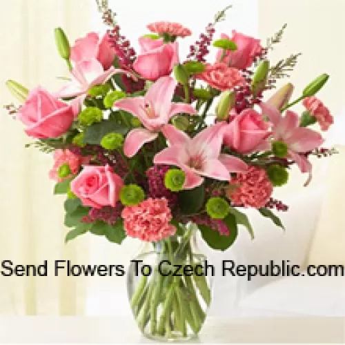 Pink Roses, Pink Carnations And Pink Lilies With Assorted Ferns And Fillers In A Glass Vase