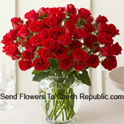 51 Roses Rouges avec quelques fougères dans un vase en verre